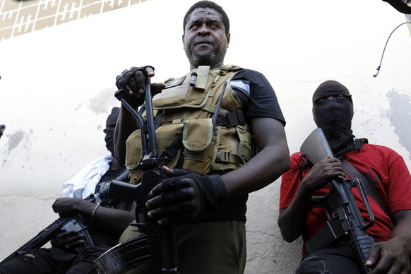 Barbecue, the leader of the "G9 and family" gang, stands with his fellow gang members after speaking to journalists in the Delmas 6 neighborhood of Port-au-Prince in Port-au-Prince, Haiti, T...