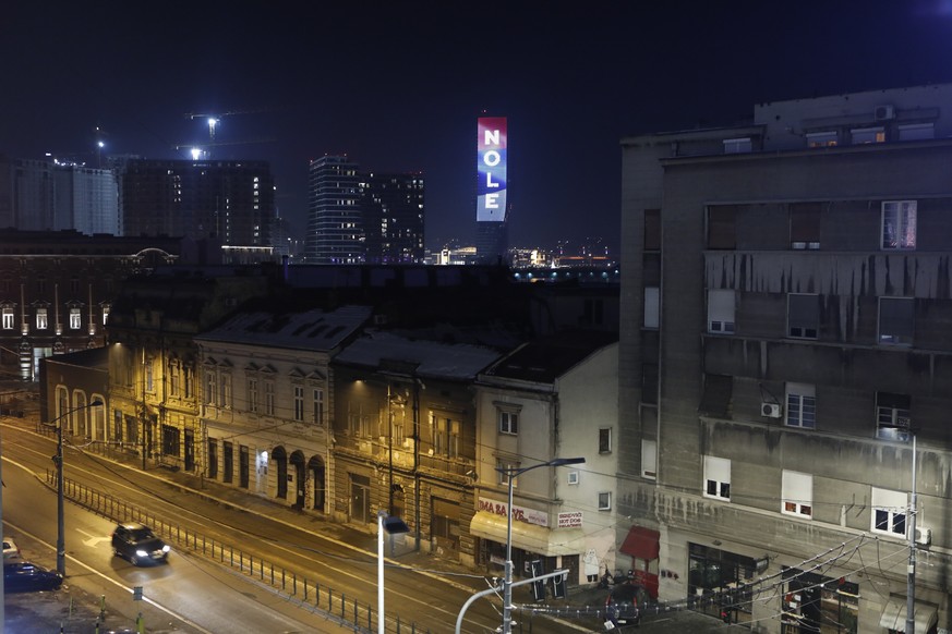 epa09689981 The word &#039;Nole&#039;, nickname of Serbian tennis player Novak Djokovic, and the colors of the Serbian flag are illuminated at the Belgrade Tower in Belgrade, Serbia, late 16 January 2 ...