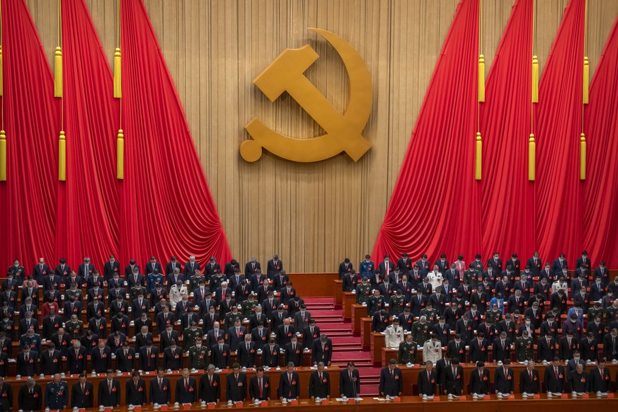Delegates stand for a moment of silence during the opening ceremony of the 20th National Congress of China&#039;s ruling Communist Party at the Great Hall of the People in Beijing, China, Sunday, Oct. ...