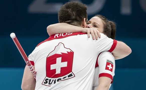 Martin Rios of Switzerland and Jenny Perret of Switzerland, from left, celebrate after the Mixed Doubles Curling semi final game between Switzerland and Olympic Athletes from Russia during the XXIII W ...