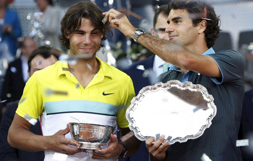 Swiss tennis player Roger Federer (R) and Spaniard Rafael Nadal pose with their trophies at the end of their Madrid Masters 1000 final match, at Magic Box pavilion, in Madrid, central Spain, 17 May 20 ...