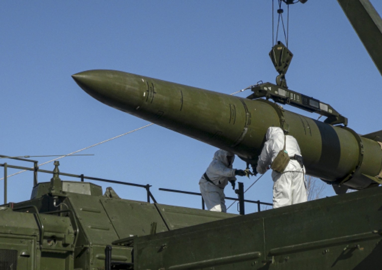 In this photo released by Russian Defense Ministry Press Service on Friday, Feb. 2, 2024, Russian troops load an Iskander missile onto a mobile launcher during drills at an undisclosed location in Rus ...