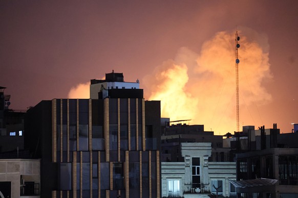 epaselect epa12788061 Smoke and flames rise behind buildings after an explosion on the second consecutive day of strikes by the US and Israel, in Tehran, Iran, 01 March 2026. A joint Israeli and US mi ...