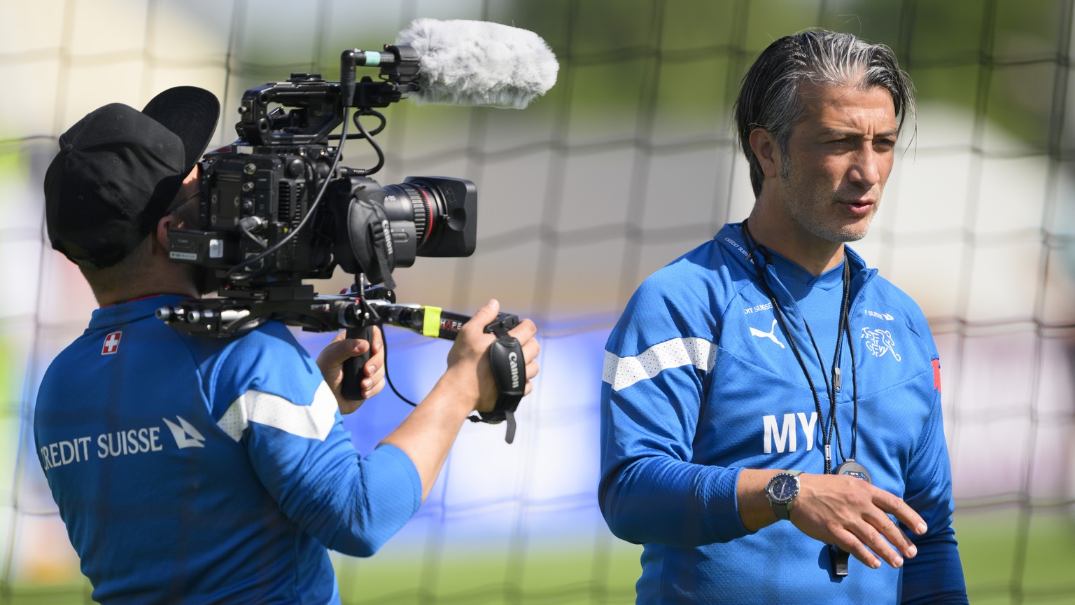 Swiss soccer team cameraman Samy Ebneter, left, films Switzerland&#039;s head coach Murat Yakin, right, during a open training session of Swiss national soccer team in preparation for the FIFA World C ...