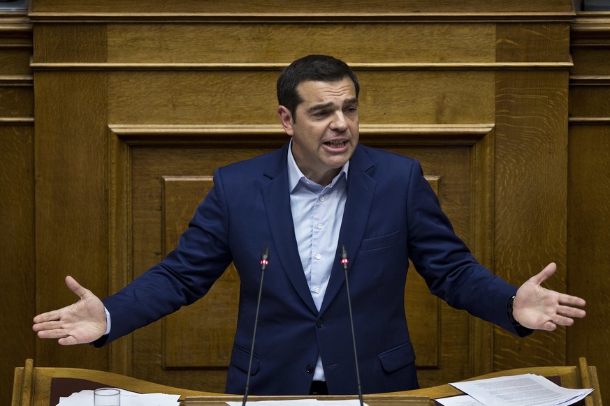 Greek Prime Minister Alexis Tsipras, speaks to lawmakers during a parliamentary session, in Athens, on Saturday, June 16, 2018. Greek lawmakers on Saturday debated for the third and final day a no-con ...