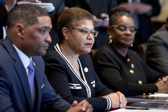 From left, Congressional Black Caucus Chairman Rep. Cedric Richmond, D-La., Rep. Karen Bass, D-Calif., Rep. Gwen Moore, D-Wis., and other members of the Congressional Black Caucus meet with President  ...