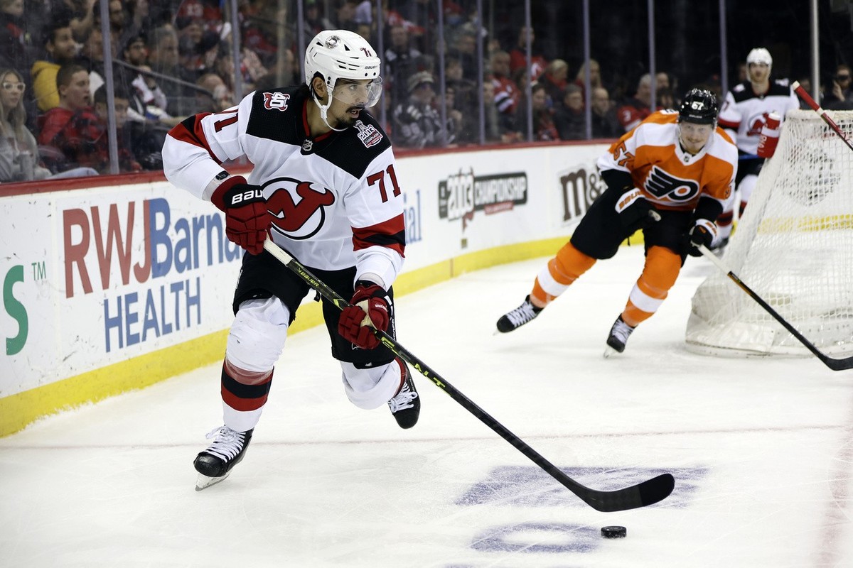 New Jersey Devils defenseman Jonas Siegenthaler (71) looks to pass the puck in front of Philadelphia Flyers right wing Wade Allison during the third period of an NHL hockey game Saturday, Feb. 25, 202 ...