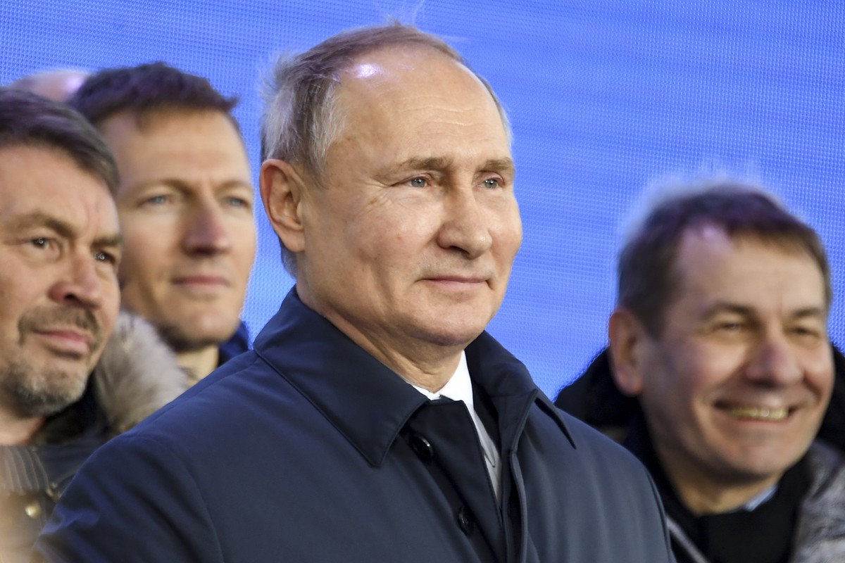 Russian President Vladimir Putin speaks to workers after riding a train across a bridge linking Russia and the Crimean peninsula in Taman, Russia, Monday, Dec. 23, 2019. Putin on Monday inaugurated a  ...