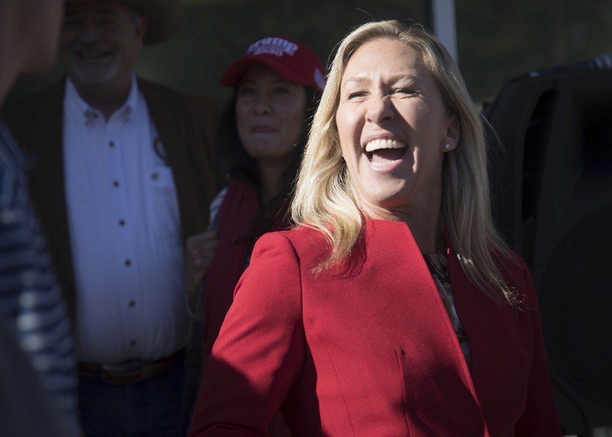 U.S. Representative-elect Marjorie Taylor Greene laughs during a campaign rally to support Senator Kelly Loeffler&#039;s campaign ahead of the January 5th runoff election for Senator at the Springhill ...