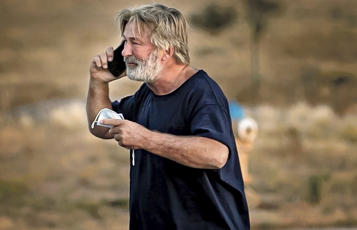 Alec Baldwin speaks on the phone in the parking lot outside the Santa Fe County Sheriff's Office in Santa Fe, N.M., after he was questioned about a shooting on the set of the film "Rust&quot ...