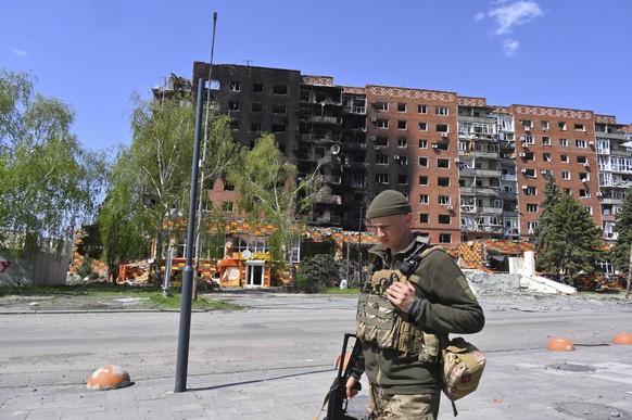 A Ukrainian soldier walks past damaged buildings in central Pokrovsk, the site of the heaviest battles with the Russian troops in the Donetsk region, Ukraine, Wednesday, April 23, 2025. (AP Photo/Mich ...