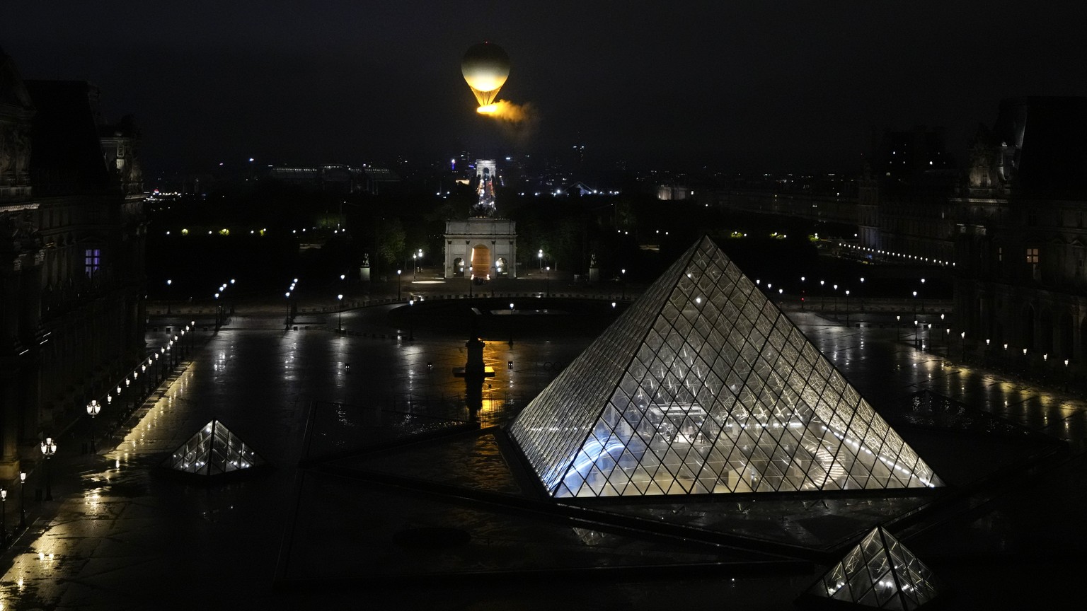 The cauldron, with the Olympic flame lit, lifts off while attached to a balloon, during the opening ceremony for the 2024 Summer Olympics in Paris, France, Friday, July 26, 2024. (AP Photo/Ricardo Maz ...