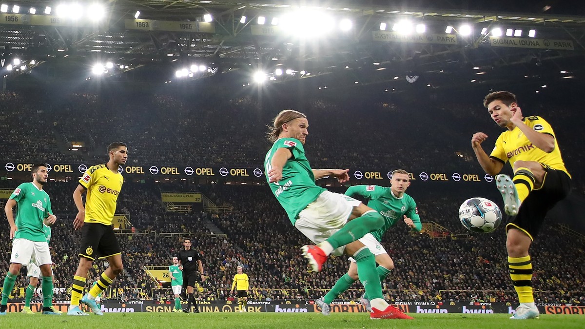 epa07877681 Bremen's Michael Rico Lang (L) in action against Dortmund's Raphael Guerreiro (R) during the German Bundesliga soccer match between Borussia Dortmund and SV Werder Bremen in Dort ...