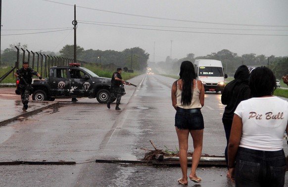 epa06660558 A handout photo made available by O Liberal shows policemen during an operation after an escape attempt in a jail of Belen, Brazil, 10 April 2018. At least 20 people died, including a pris ...