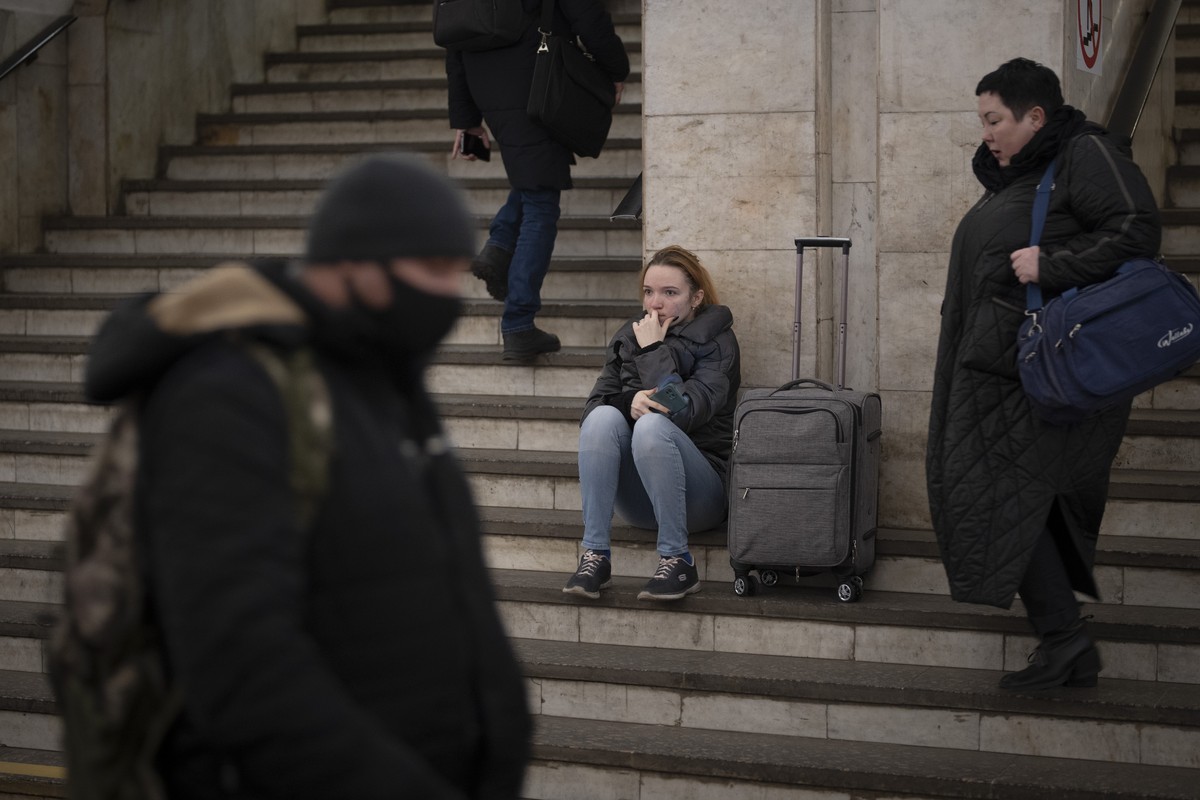 People walk in a subway to get a train as they leave the city of Kyiv, Ukraine, Thursday, Feb. 24, 2022. Russian President Vladimir Putin on Thursday announced a military operation in Ukraine and warn ...