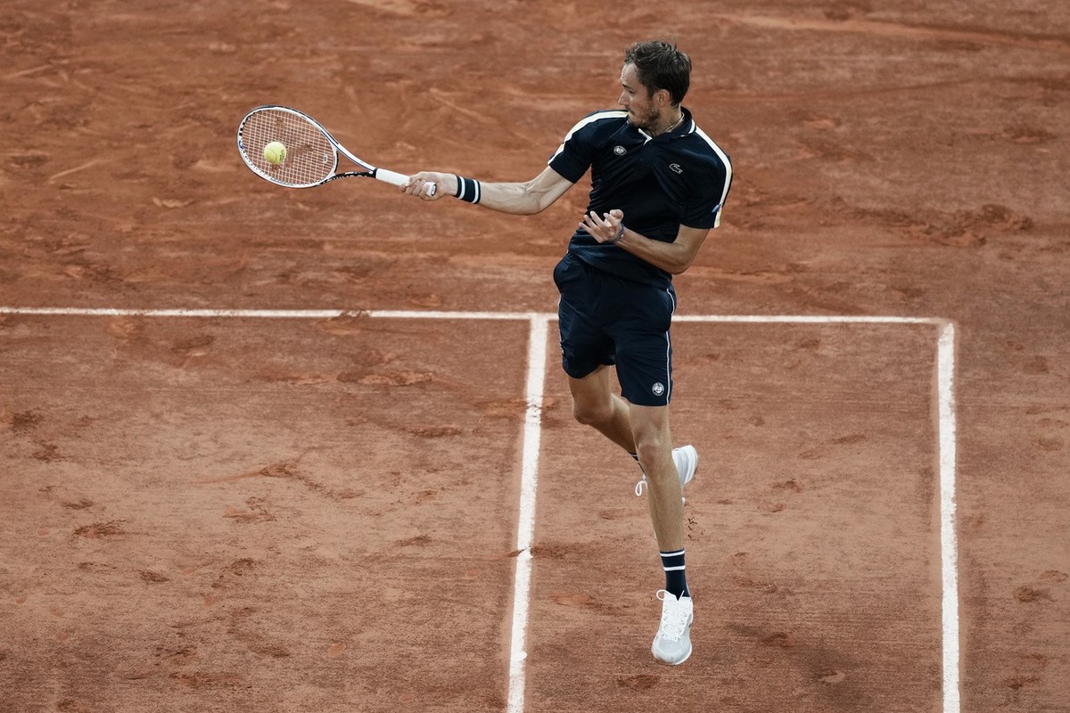 Russia's Daniil Medvedev slams a forehand to Stefanos Tsitsipas of Greece during their quarterfinal match of the French Open tennis tournament at the Roland Garros stadium Tuesday, June 8, 2021 i ...