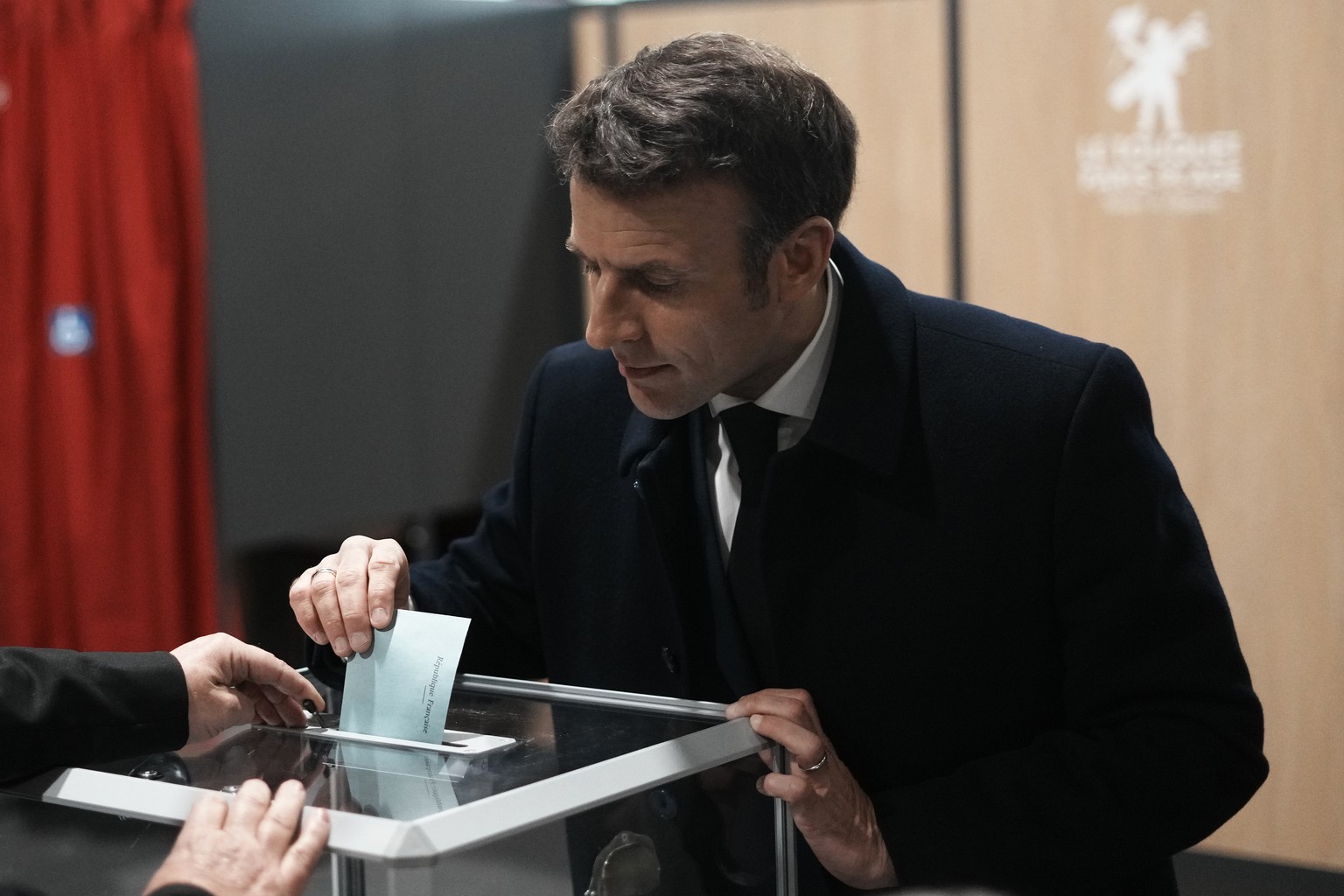 French President and centrist presidential candidate for reelection Emmanuel Macron casts his ballot for the first round of the presidential election, Sunday, April 10, 2022 in Le Touquet, northern Fr ...