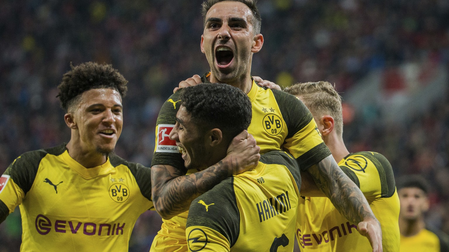 In this Sept. 29, 2018 photo Dortmund&#039;s Paco Alcacer, top, celebrates with Achraf Hakim, front, and Jadon Sancho after scoring his side&#039;s third goal in the German Bundesliga soccer match bet ...