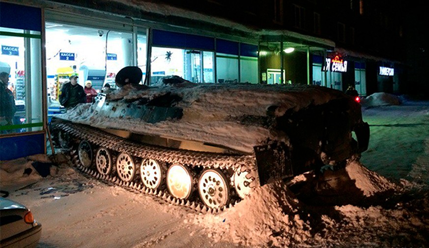 An armored personnel carrier sits next to a shop window it crashed into in Apatity, Murmansk region on the Arctic Kola Peninsula, Russia, Wednesday, Jan. 10, 2018. Russian police say that a drunken ma ...