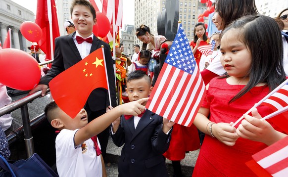 epa07886979 Children hold Chinese and US flags during a celebration held by the area?s Chinese-American community for China&#039;s National Day, which commemorates the founding of People&#039;s Republ ...