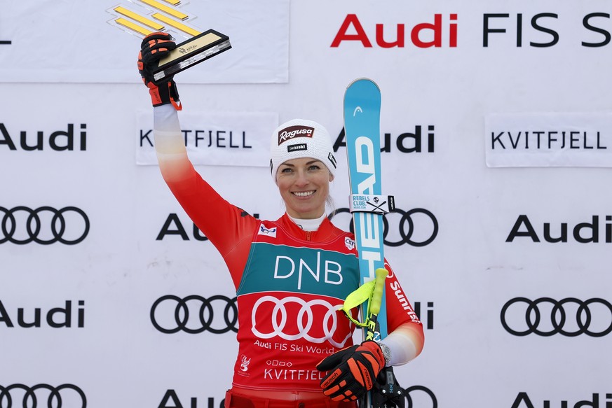 Switzerland's Lara Gut Behrami celebrates on the podium after winning an alpine ski, women's World Cup super-G race, in Kvitfjell, Norway, Saturday, March 2, 2024. (AP Photo/Alessandro Trova ...