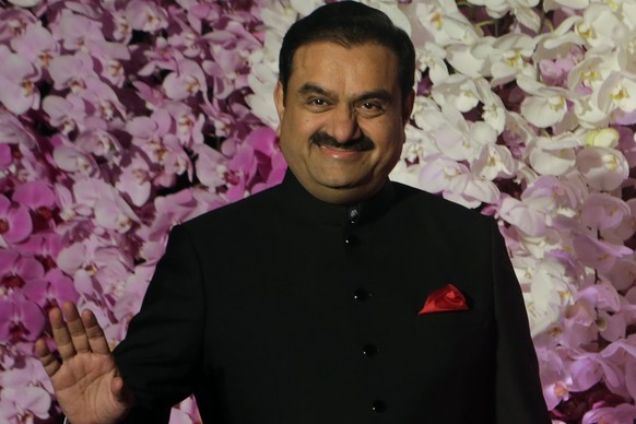 FILE- Adani Group Gautam Chairman Gautam Adani poses during Akash Ambani's wedding reception in Mumbai, India, March 10, 2019. Asia