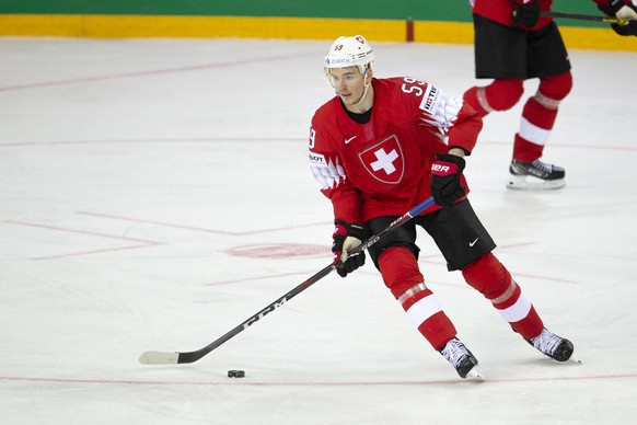 Switzerland's forward Dario Simion controls thee puck, during the IIHF 2021 World Championship preliminary round game between Switzerland and Sweden, at the Olympic Sports Center, in Riga, Latvia, Tuesday, May 25, 2021. The game is played behind closed doors due to the coronavirus COVID-19 pandemic. (KEYSTONE/Salvatore Di Nolfi)