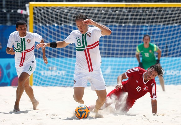 BAKU, AZERBAIJAN - JUNE 28: Jose Maria Fonseca (8) of Portugal evades Philipp Boroer (10) of Switzerland during the Men&#039;s Beach Soccer bronze medal match between Switzerland and Portugal on day s ...