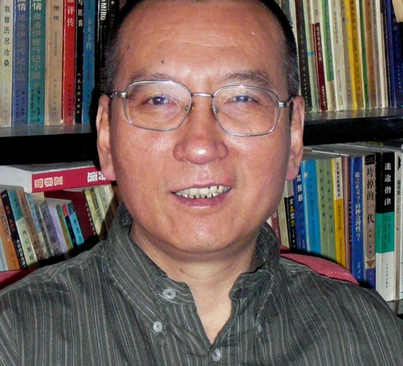 FILE - In this file photo taken in April 2008, Chinese dissident Liu Xiaobo poses for a photographer in China. A Chinese nationalist newspaper says Americans politicians are resorting to petty actions ...