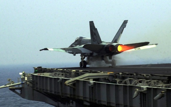 A F/A-18 Hornet takes off from the American aircraft carrier USS Carl Vinson, in the Arabian Sea, Tuesday Dec. 18, 2001. The aircraft carrier Carl Vinson and it&#039;s battlegroup are part of the &quo ...