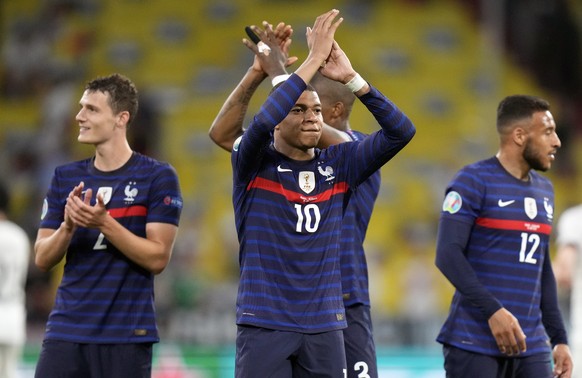 France's Kylian Mbappe, centre, salutes the fans after the Euro 2020 soccer championship group F match between France and Germany at the Allianz Arena in Munich, Germany, Tuesday, June 15, 2021. France won the match 1-0. (AP Photo/Matthias Schrader, Pool)