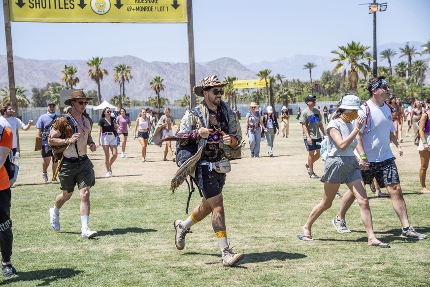 Festivalgoers are seen running toward the merchandise tent at the Coachella Music &amp; Arts Festival at the Empire Polo Club on Saturday, April 16, 2022, in Indio, Calif. (Photo by Amy Harris/Invisio ...