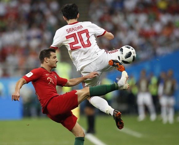 Portugal&#039;s Cedric, left, and Iran&#039;s Sardar Azmoun challenge for the ball during the group B match between Iran and Portugal at the 2018 soccer World Cup at the Mordovia Arena in Saransk, Rus ...