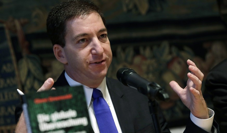Glenn Greenwald, the U.S. journalist who wrote the first stories about the NSA&#039;s global spy program, gestures during a news conference in Munich, southern Germany, Monday, Dec. 1, 2014. Greenwald ...