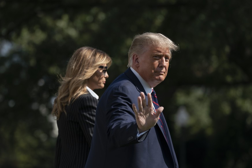 President Donald Trump and first lady Melania Trump walk to board Marine One at the White House, Tuesday, Sept. 29, 2020, in Washington, for the short trip to Andrews Air Force Base en route to Clevel ...