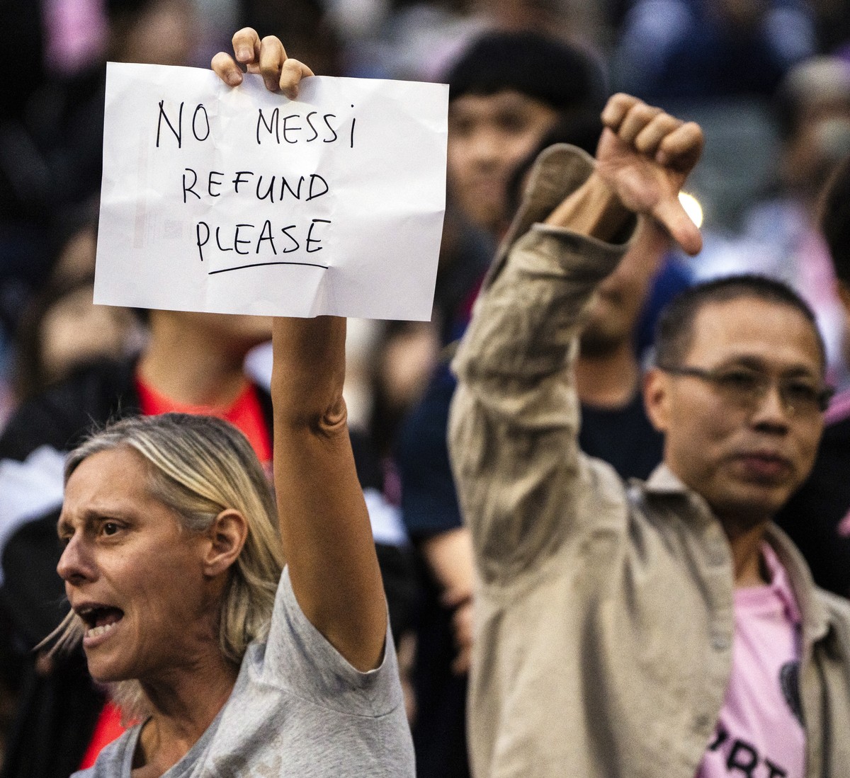 Fans react during the friendly soccer match between Hong Kong Team and US Inter Miami CF at the Hong Kong Stadium in Hong Kong, Sunday, Feb. 4, 2024. Lionel Messi's non-appearance was a disappoin ...