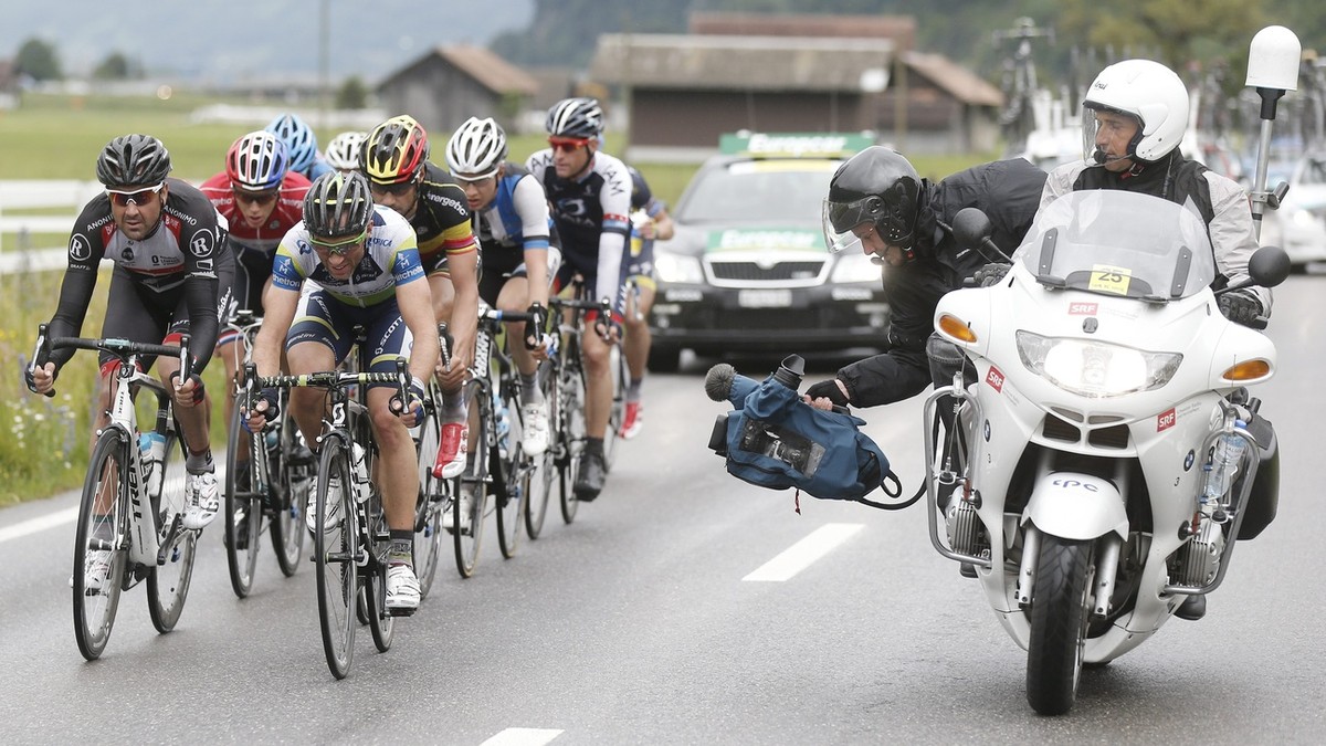 A SRF camera team films the leading group with Switzerland's Michael Albasini of team Orica GreenEDGE in front, near Meiringen BE during the third stage of the Tour de Suisse cycling race over 20 ...