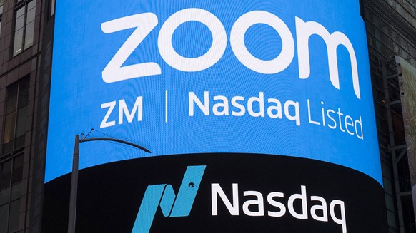 FILE - This April 18, 2019, file photo shows a sign for Zoom Video Communications ahead of their Nasdaq IPO in New York. A U.S. government committee that reviews foreign investment in telecom is probi ...