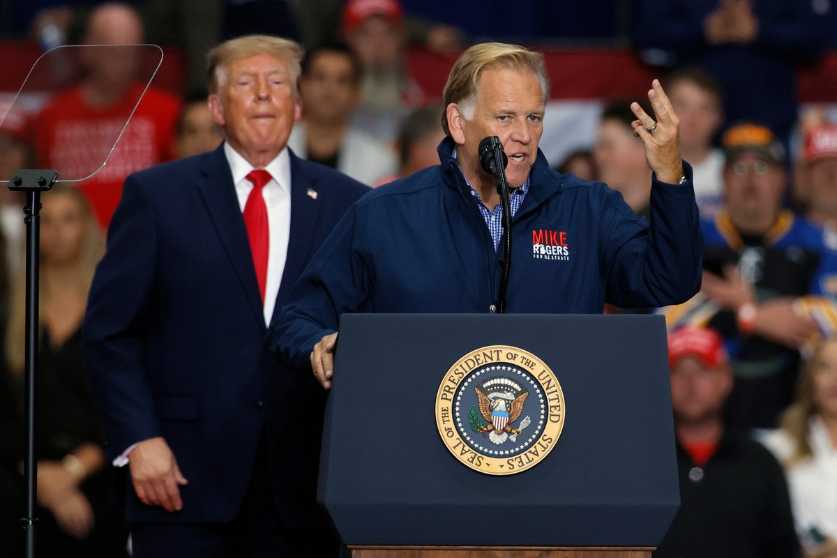 Mike Rogers, a Michigan Republican candidate for Senate, speaks as President Donald Trump listens during a campaign rally at McMorran Place Arena in Port Huron, Mich., Sunday, Oct. 25, 2026. (AP Photo ...