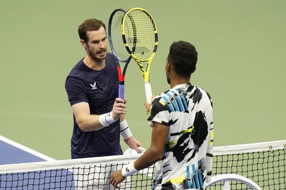 Felix Auger-Aliassime, of Canada, right, taps rackets with Andy Murray, of Great Britain, during the third round of the U.S. Open tennis championships, Thursday, Sept. 3, 2020, in New York. Auger-Alia ...