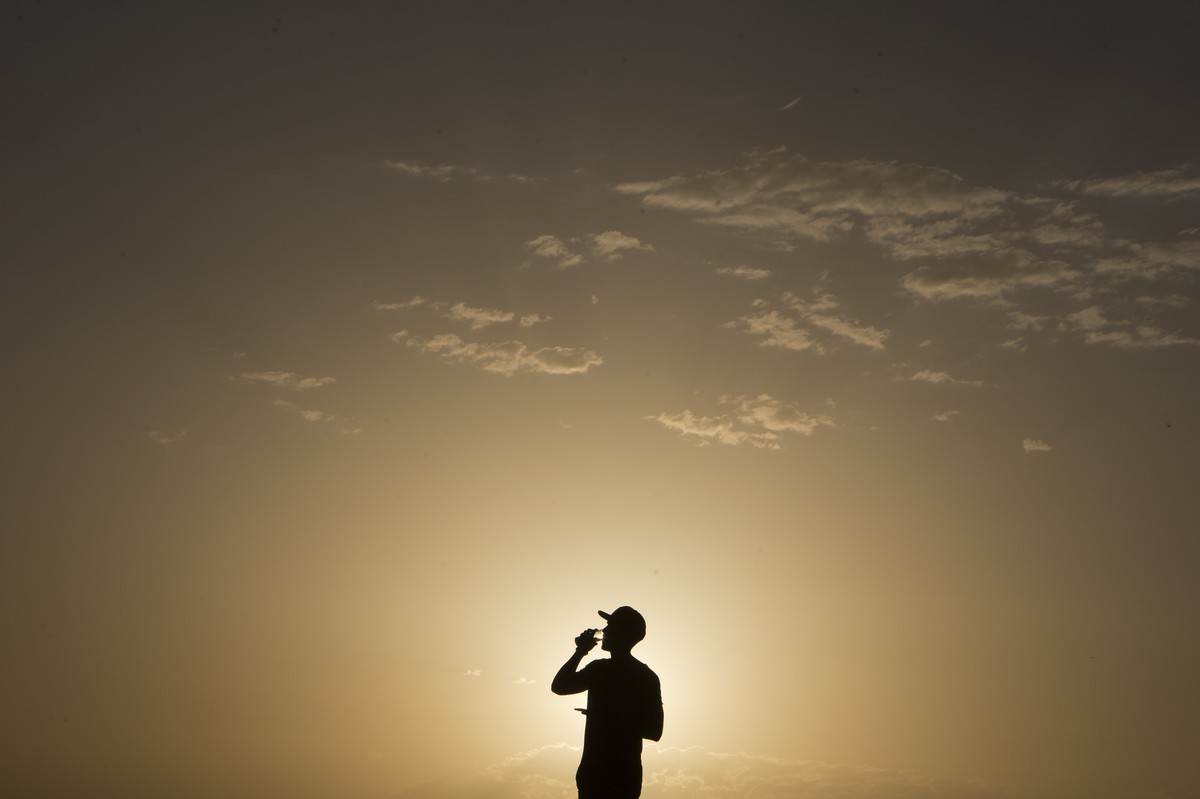 FILE - In this Sept. 6, 2016 file photo, a youth takes a drink on a hill overlooking the city after a long hot day in Madrid, Spain. Earth’s 16-month sizzling streak of record high temperatures is fin ...
