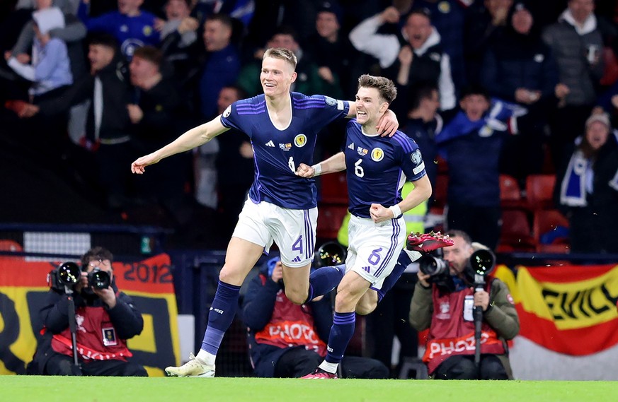 epa10547868 Scott McTominay (L) of Scotland celebrates with teammate Kieran Tierney after scoring his second goal during the UEFA EURO 2024 qualification match between Scotland and Spain in Glasgow, B ...