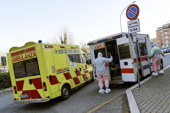 epa08337439 A general view of health workers outside the premises of the Courtyard hotel by Marriott Rome Central Park, which has been made operational and available for the transfer of discharged pat ...