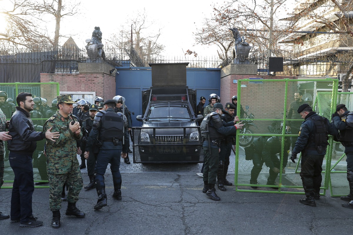 Police guard the British Embassy during an anti-UK protest in Tehran, Iran, Sunday, Jan. 12, 2020. Dozens of hard-liners later gathered outside the embassy on Sunday, chanting "Death to England&q ...