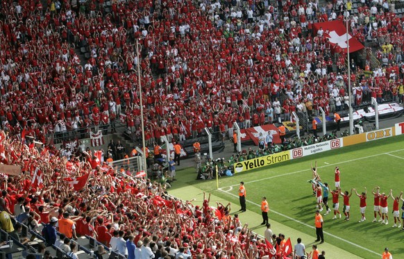 Switzerland's players celebrate with their fans after the Germany 2006 Soccer World Cup, Group G, soccer match between Togo and Switzerland at Dortmund's stadium, Germany, Monday, June 19, 2 ...