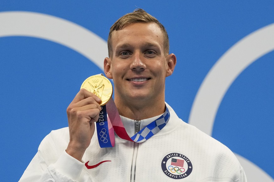 Caeleb Dressel, of United States, poses after winning the gold medal in the men&#039;s 100-meter butterfly final at the 2020 Summer Olympics, Saturday, July 31, 2021, in Tokyo, Japan. (AP Photo/Gregor ...