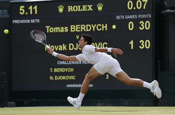 Serbia&#039;s Novak Djokovic returns to Czech Republic&#039;s Tomas Berdych during their Men&#039;s Singles Quarterfinal Match on day nine at the Wimbledon Tennis Championships in London Wednesday, Ju ...