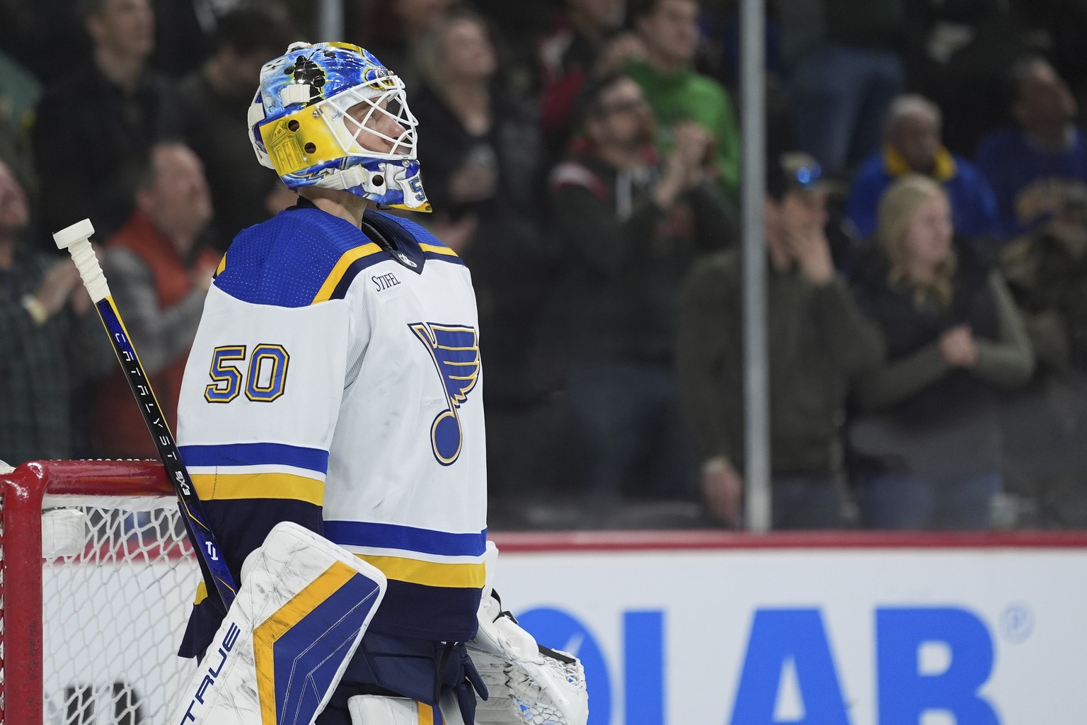 St. Louis Blues goaltender Jordan Binnington (50) looks at the video board after giving up a goal to Minnesota Wild center Marco Rossi during the second period of an NHL hockey game Saturday, March 23 ...