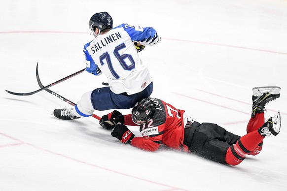 epa07603680 Jere Sallinen (L) of Finland in action against Thomas Chabot (R) of Canada during the IIHF World Championship ice hockey final between Canada and Finland at the Ondrej Nepela Arena in Brat ...