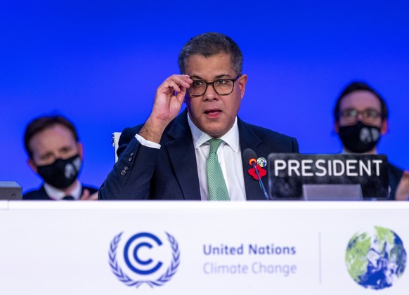 epa09580910 Alok Sharma (C), President of COP26 speaks during the Plenary session of the COP26 UN Climate Change Conference in Glasgow, Britain, 13 November 2021. The 2021 United Nations Climate Chang ...